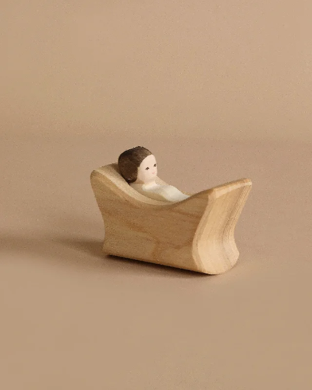 detailed and intricate wooden toys                   Ostheimer Child In Cradle